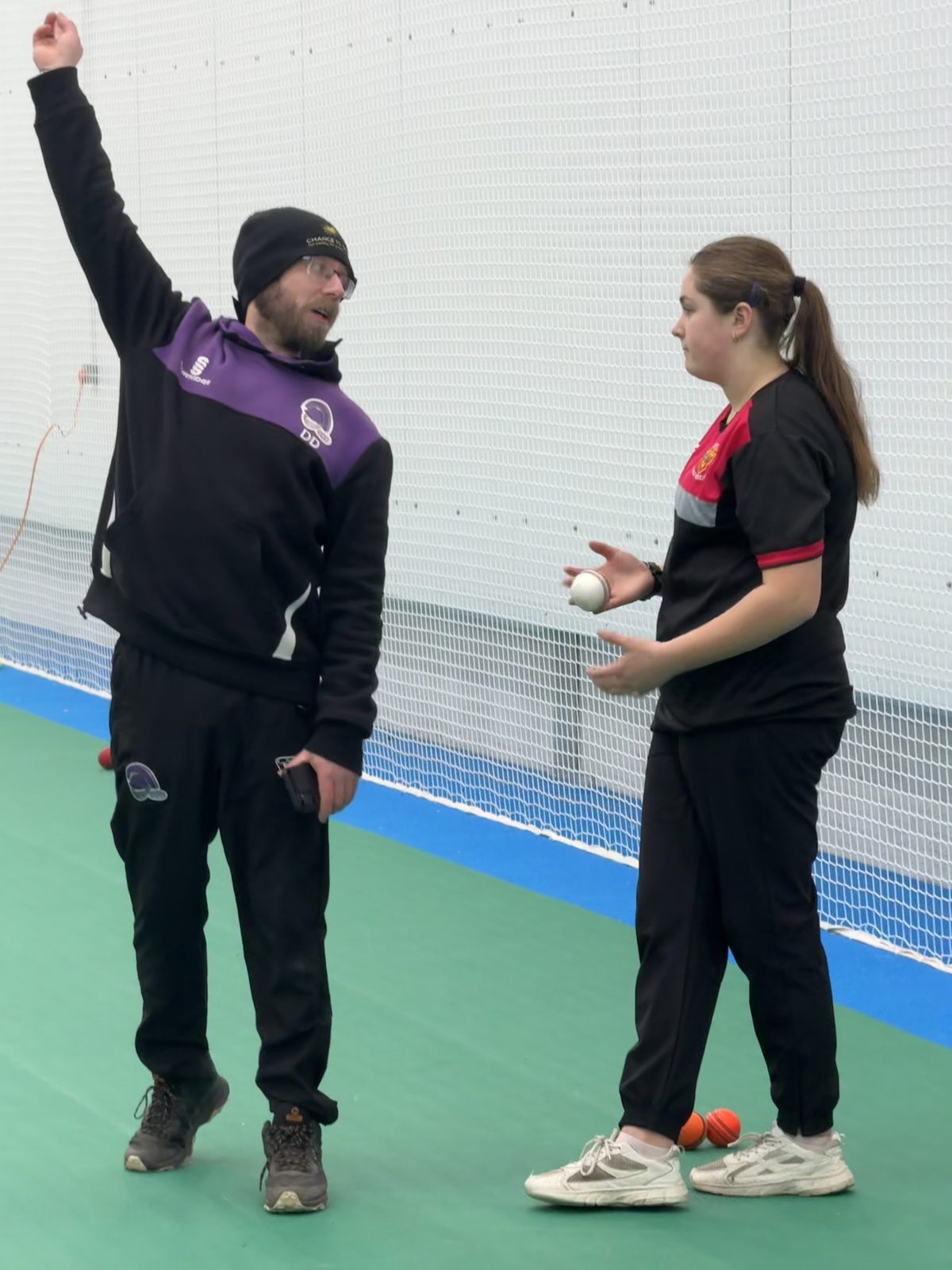 Centurion coach David Digby demonstrating a bowling release to a young player in an indoor net lane